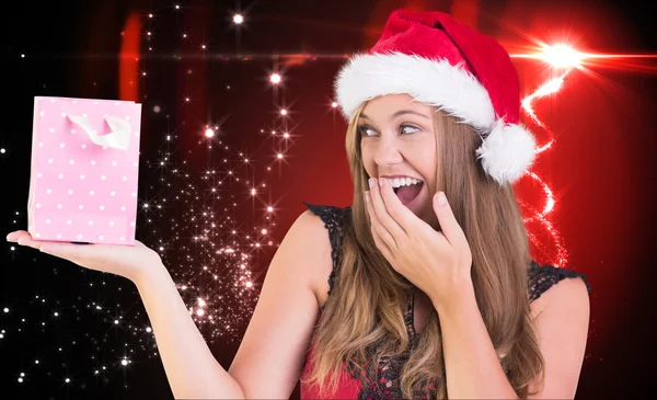 Festive blonde holding a gift bag — Stock Photo, Image