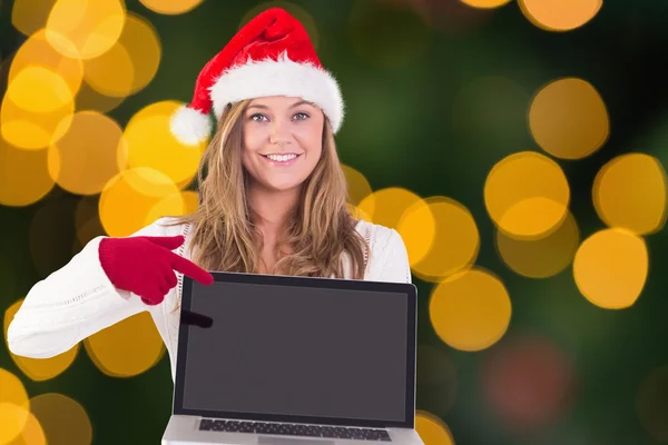 Samengestelde afbeelding van feestelijke blonde met een laptop — Stockfoto