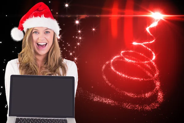 Festive blonde showing a laptop — Stock Photo, Image