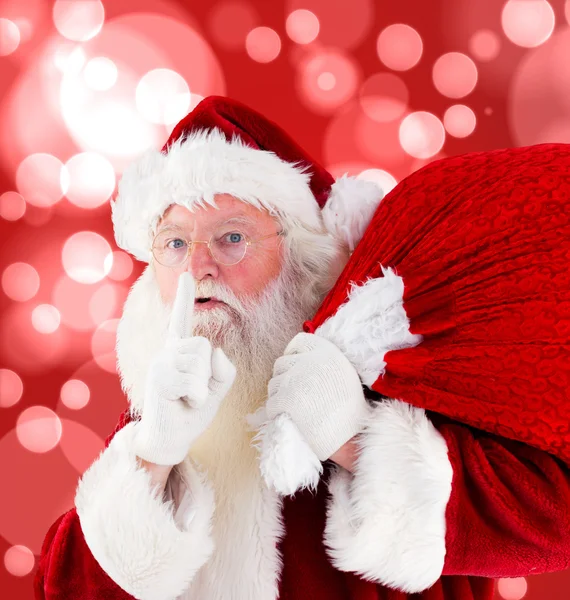 Composite image of santa claus carrying sack — Stock Photo, Image