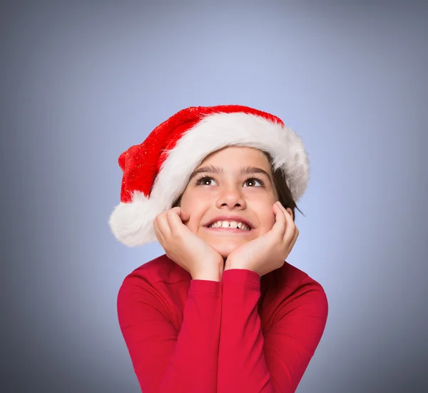 Imagen compuesta de una niñita festiva sonriendo y mirando hacia arriba — Foto de Stock