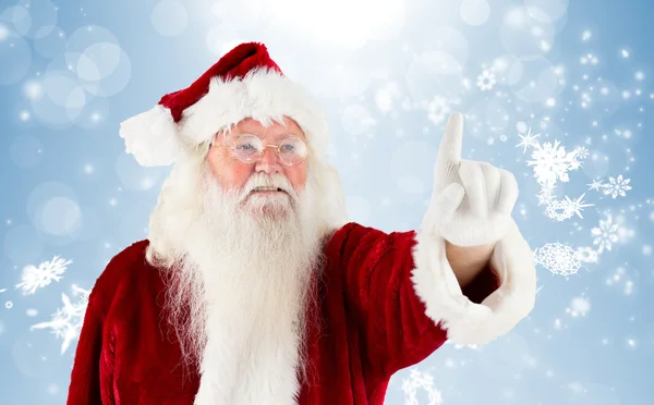 Composite image of santa claus pointing Stock Picture