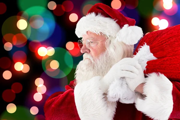 Composite image of santa claus carrying sack Royalty Free Stock Photos