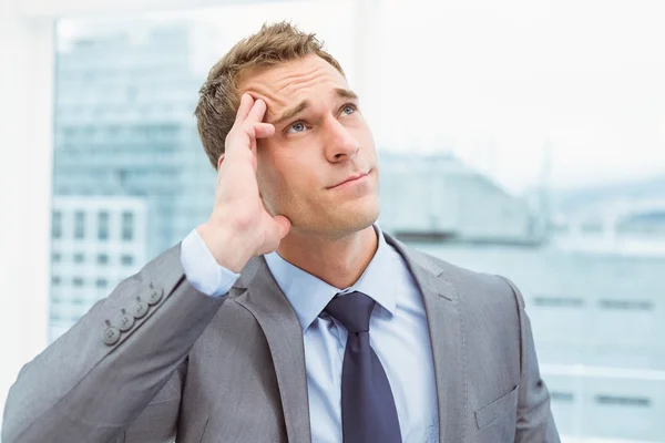 Businessman with severe headache at office — Stock Photo, Image