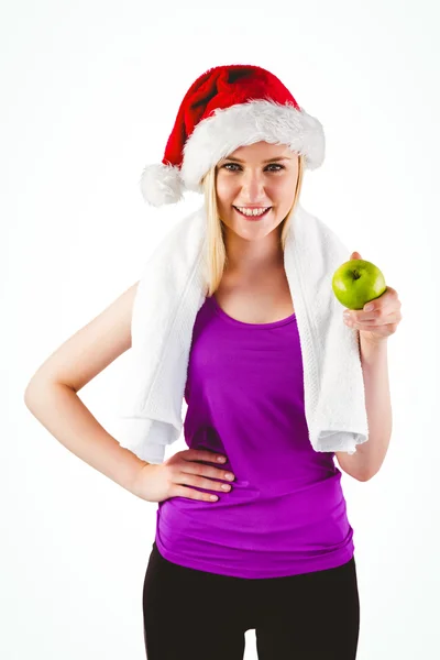 Festlich gekleidete Blondine lächelt in die Kamera und hält Apfel — Stockfoto