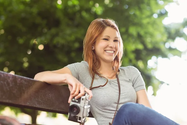 Pretty redhead holding her camera — Stock Photo, Image