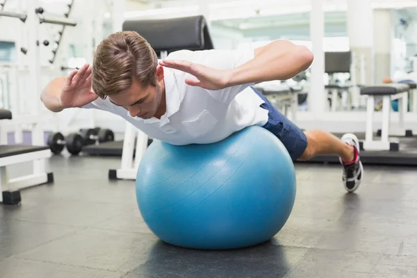 Man in plank position on exercise ball — Stock Photo, Image