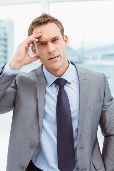 Businessman with severe headache at office — Stock Photo, Image