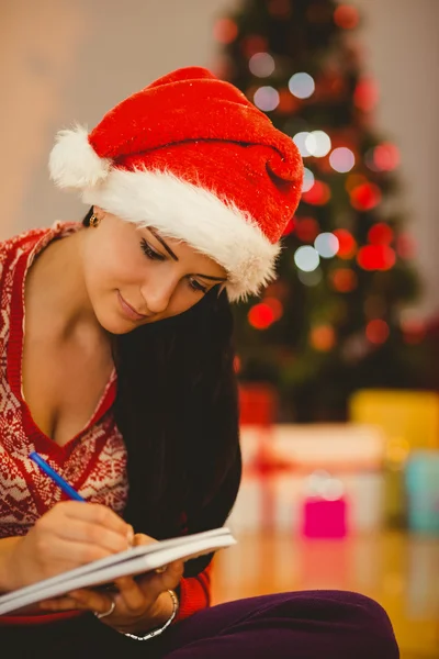 Festive brunette writing her list — Stock Photo, Image