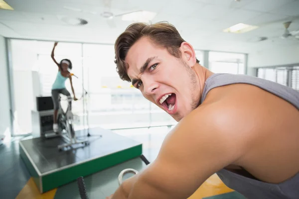 Handsome man smiling at camera in spin class — Stock Photo, Image