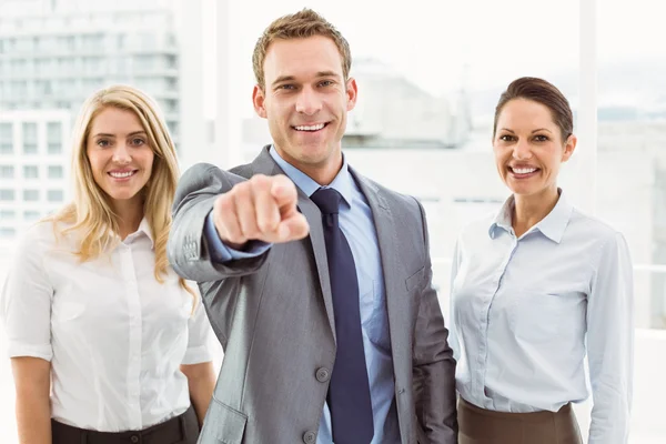 Businessman pointing at you with colleagues in office — Stock Photo, Image