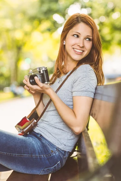 Pretty redhead holding her camera — Stock Photo, Image