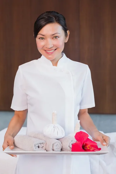 Confident masseur holding rolled up towels — Stock Photo, Image