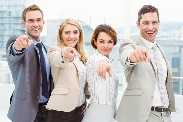 Happy business people pointing at you in office — Stock Photo, Image