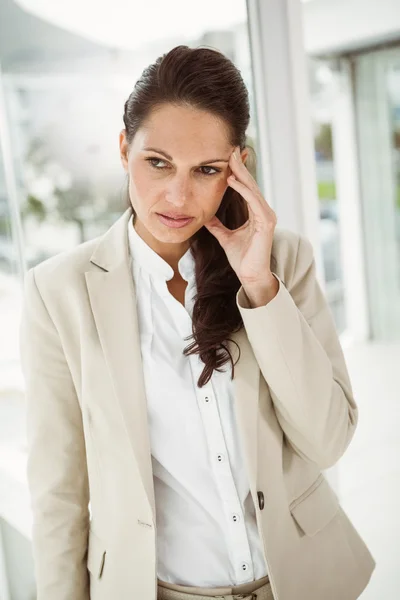 Businesswoman with headache at office — Stock Photo, Image