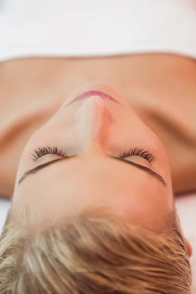 Beautiful woman lying on massage table — Stock Photo, Image