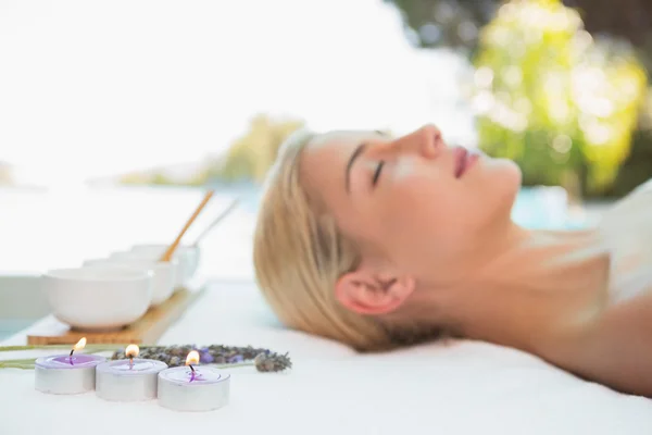 Beautiful woman lying on massage table — Stock Photo, Image