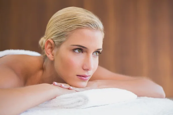 Beautiful woman lying on massage table — Stock Photo, Image