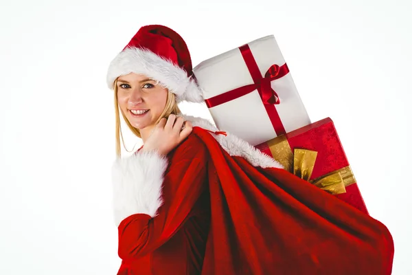 Rubia festiva llevando saco de regalos — Foto de Stock