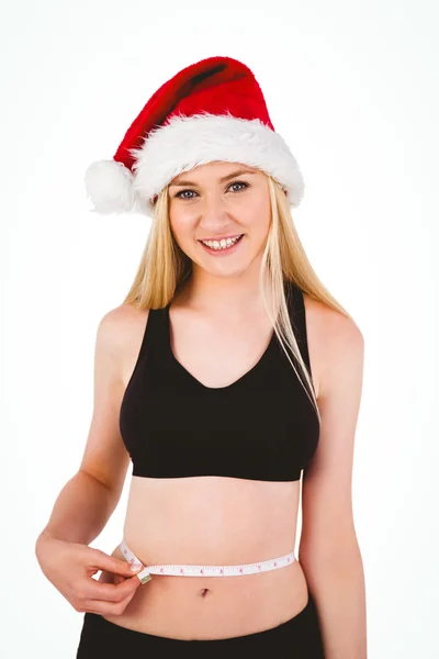 Fit festive young blonde measuring her waist — Stock Photo, Image