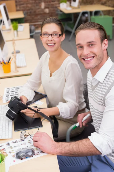 Casual photo editors with camera in office — Stock Photo, Image