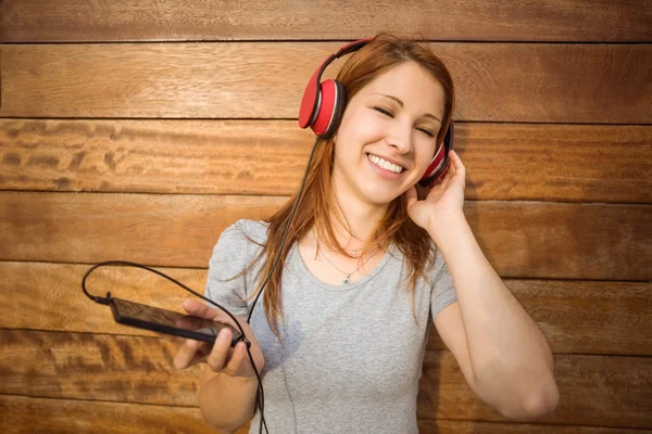 Portret van een speelse vrouw dansen terwijl u luistert naar muziek — Stockfoto