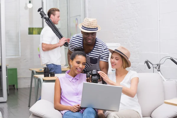 Photo editors using laptop while looking at camera — Stock Photo, Image