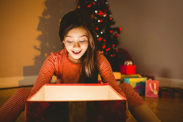 Küçük kız parlayan bir Noel hediyesi açma — Stok fotoğraf