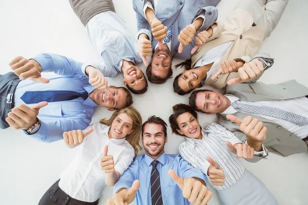 Negócios gesticulando polegares para cima — Fotografia de Stock