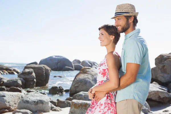 Gorgeous couple embracing by the coast — Stock Photo, Image