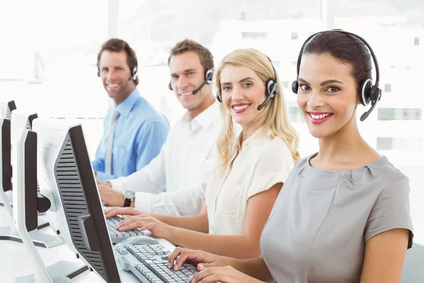Business people with headsets using computers in office — Stock Photo, Image