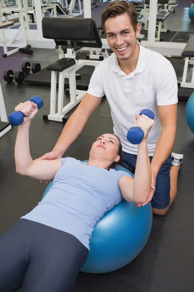 Personal trainer aiutare il cliente a sollevare i manubri — Foto Stock