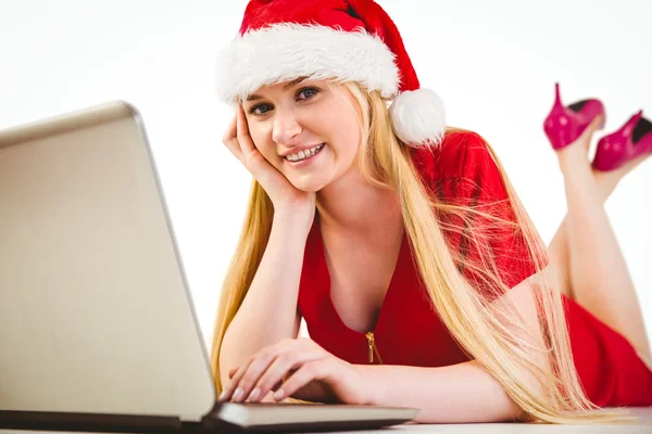 Festive blonde using a laptop — Stock Photo, Image