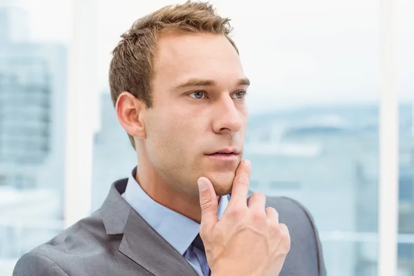 Thoughtful young businessman looking away — Stock Photo, Image
