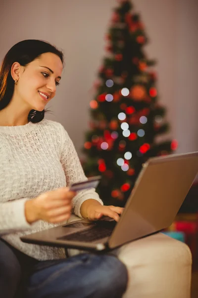 Pretty brunette shopping online at christmas — Stock Photo, Image