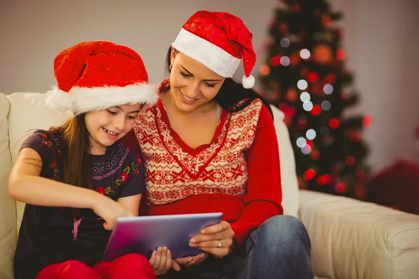 Festive mother and daughter using tablet pc — Stock Photo, Image