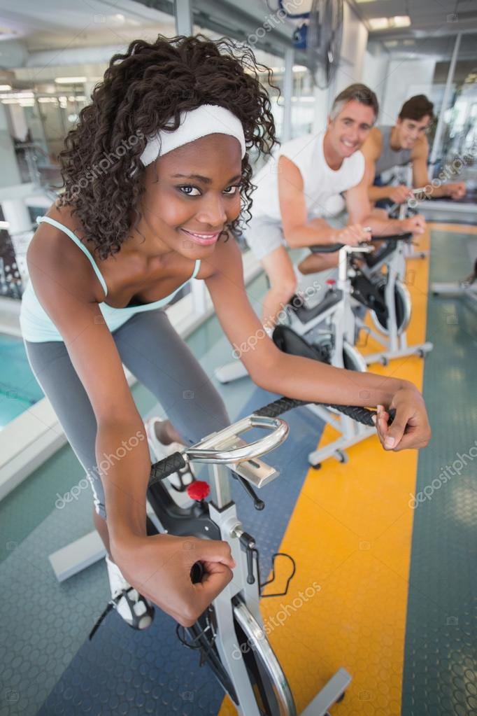 Three fit people working out on exercise bikes Stock Photo Wavebreakmedia 56904159