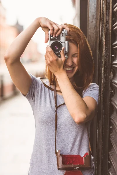 Jolie rousse prenant une photo avec caméra rétro — Photo