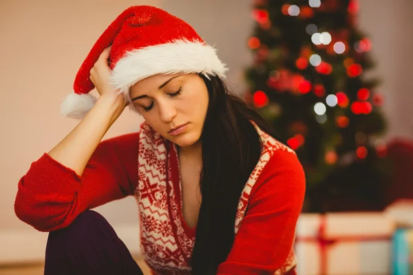 Festive brunette feeling sad at christmas — Stock Photo, Image