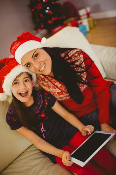 Festive mother and daughter using tablet pc — Stock Photo, Image