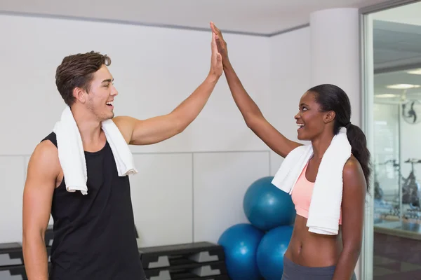 Personal trainer and client high fiving — Stock Photo, Image
