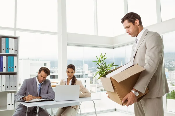 Businessman carrying his belongings in box — Stock Photo, Image