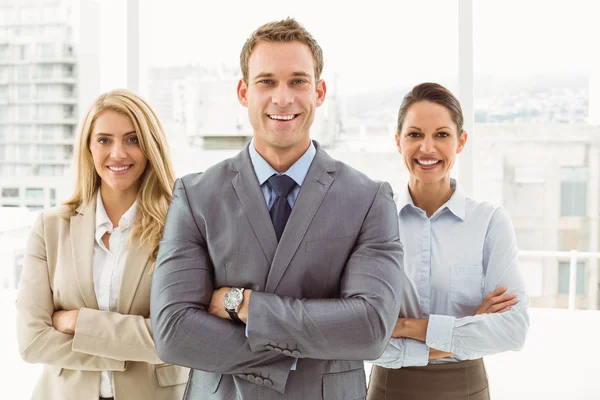Young business people with arms crossed in office — Stock Photo, Image