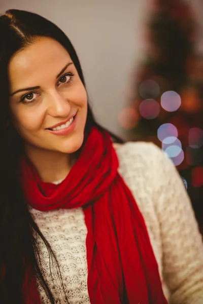 Pretty brunette relaxing at christmas — Stock Photo, Image