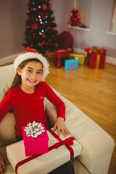 Niña festiva sonriendo a la cámara con regalos — Foto de Stock