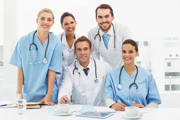 Male and female doctors working on reports — Stock Photo, Image