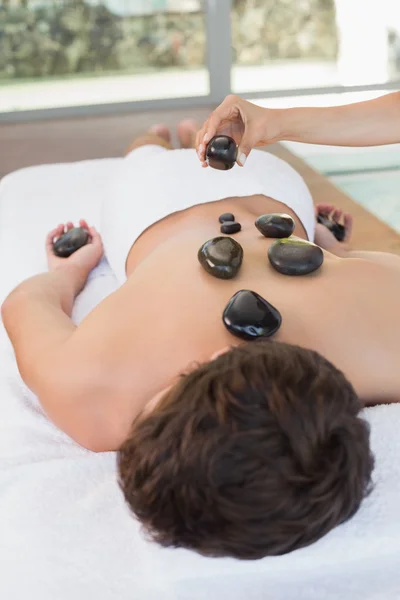 Man receiving stone massage — Stock Photo, Image