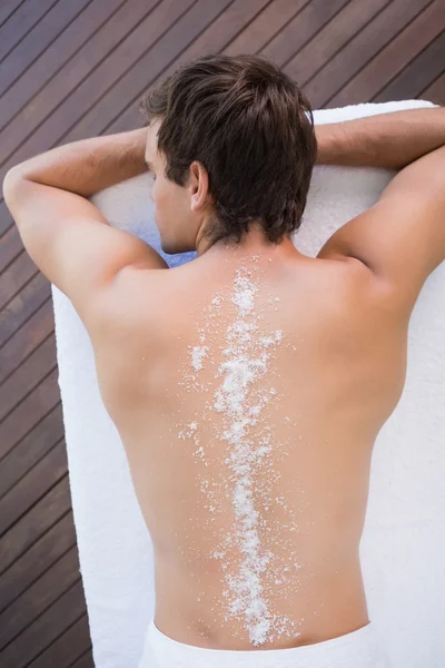 Man on massage table with powder on back — Stock Photo, Image