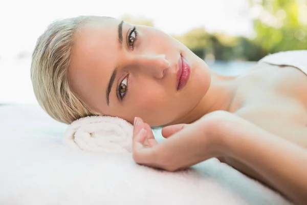 Beautiful woman lying on massage table — Stock Photo, Image