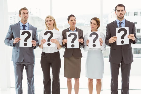 Business people holding question mark signs — Stock Photo, Image